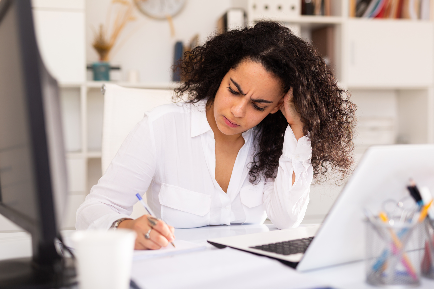 Frustrated woman working alone in office